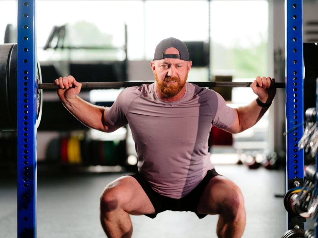 trainer with kettlebell (CrossFit NWA) Lululemon trainer racking a kettlebell at CrossFit NWA, fitness brand photography